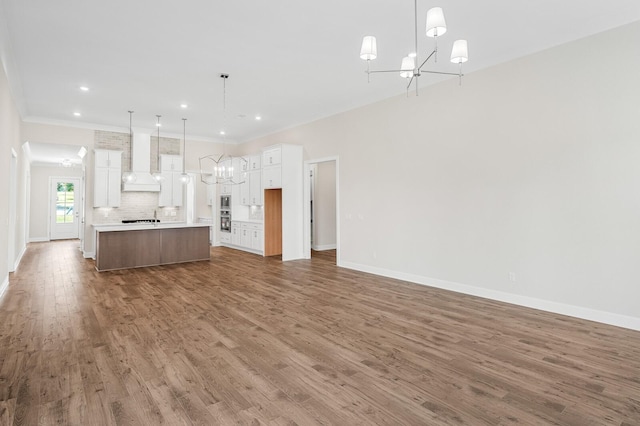 7503 Old Nashville Rd, Fairview, TN 37062 - unfurnished living room with a chandelier, wood finished floors, crown molding, and recessed lighting