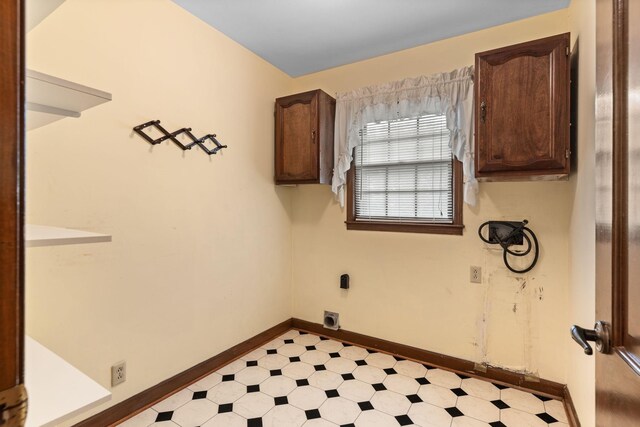 7125 Bidwell Rd, Joelton, TN 37080 - laundry area featuring electric dryer hookup, light floors, baseboards, and cabinet space