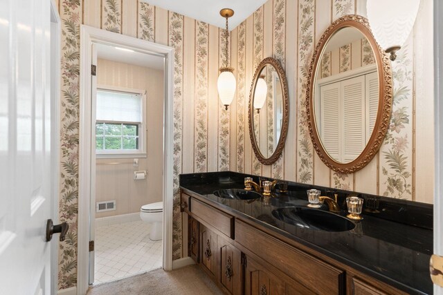 7125 Bidwell Rd, Joelton, TN 37080 - full bathroom with toilet, double vanity, and tile patterned flooring