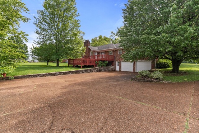 7125 Bidwell Rd, Joelton, TN 37080 - view of front of property featuring concrete driveway, a wooden deck, a chimney, brick siding, and a garage