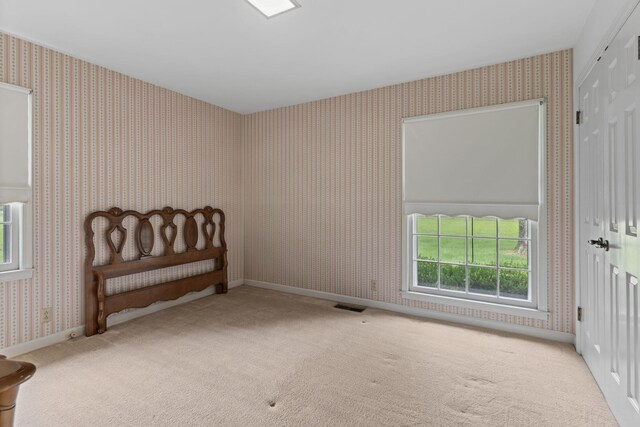 7125 Bidwell Rd, Joelton, TN 37080 - carpeted bedroom featuring wallpapered walls, a closet, and baseboards