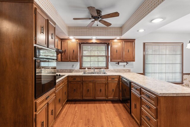 7125 Bidwell Rd, Joelton, TN 37080 - kitchen with black appliances, a sink, a peninsula, and light countertops
