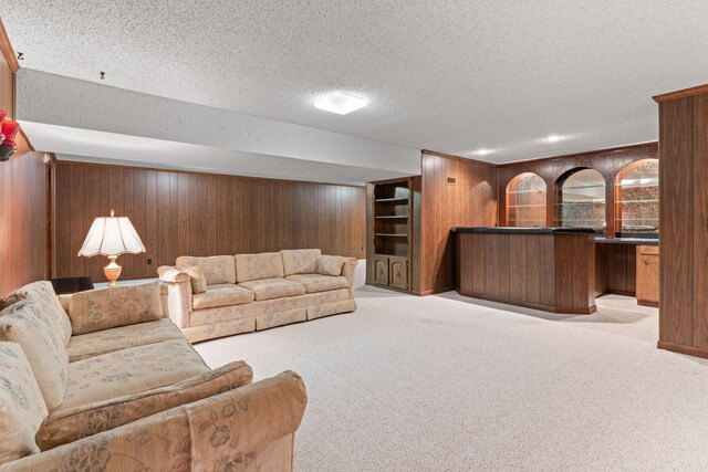 7125 Bidwell Rd, Joelton, TN 37080 - carpeted living room featuring bar, wood walls, and a textured ceiling