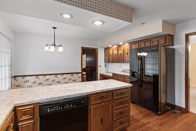 7125 Bidwell Rd, Joelton, TN 37080 - kitchen with black appliances, a chandelier, dark wood finished floors, light countertops, and decorative light fixtures