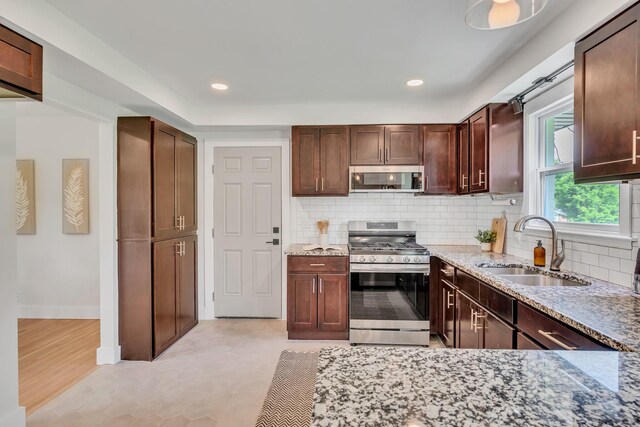 1192 Dalemere Dr, Nashville, TN 37207 - kitchen with stainless steel appliances, a sink, tasteful backsplash, light stone counters, and recessed lighting