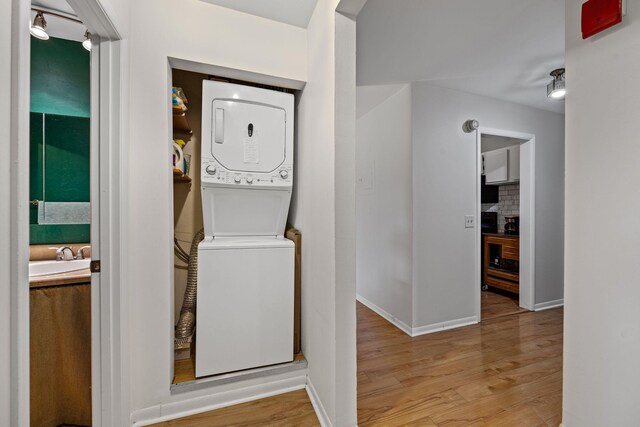 4425 Westlawn Dr Unit A301, Nashville, TN 37209 - laundry room featuring stacked washer / dryer, wood finished floors, and baseboards