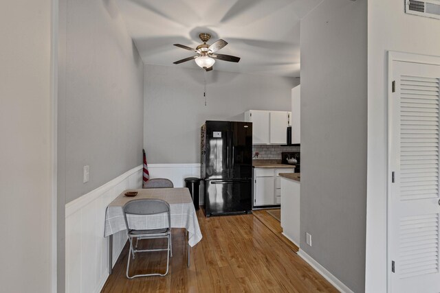 4425 Westlawn Dr Unit A301, Nashville, TN 37209 - kitchen with freestanding refrigerator, ceiling fan, white cabinetry, wainscoting, and wood finished floors