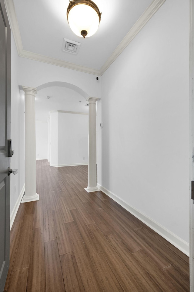 1010 16th Ave S Unit 301, Nashville, TN 37212 - spare room featuring decorative columns, arched walkways, wood finished floors, ornamental molding, and baseboards