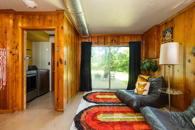 4600 Saunders Ave, Nashville, TN 37216 - sitting room with wooden walls, washer and clothes dryer, a textured ceiling, light flooring, and ornamental molding