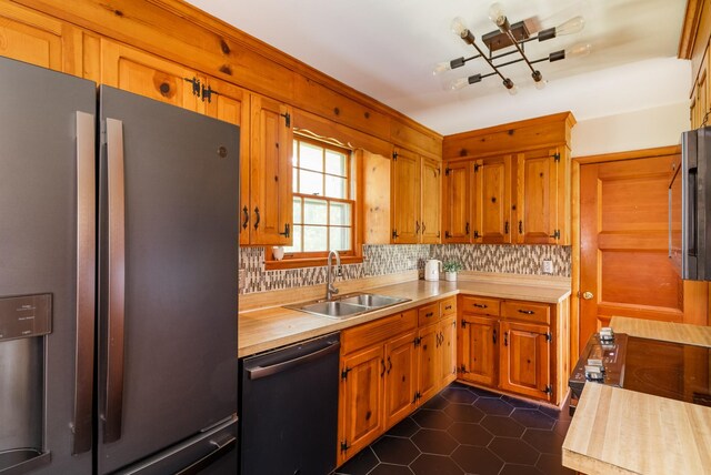 4600 Saunders Ave, Nashville, TN 37216 - kitchen featuring appliances with stainless steel finishes, a sink, decorative backsplash, wooden counters, and dark tile patterned floors