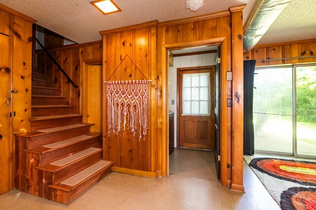 4600 Saunders Ave, Nashville, TN 37216 - staircase featuring wood walls, tile patterned floors, and a textured ceiling