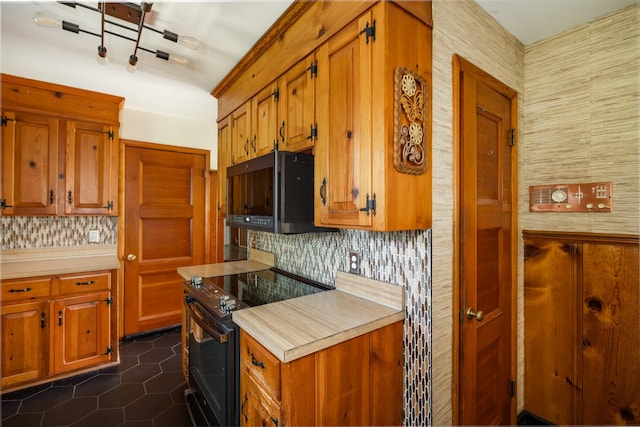 4600 Saunders Ave, Nashville, TN 37216 - kitchen featuring black appliances, decorative backsplash, light countertops, and dark tile patterned flooring