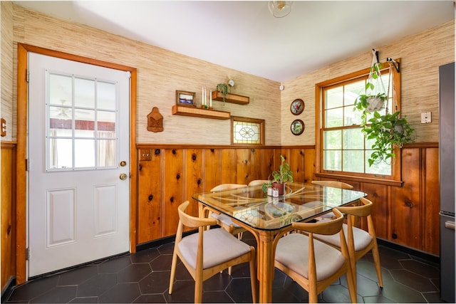4600 Saunders Ave, Nashville, TN 37216 - dining space featuring a wainscoted wall, wooden walls, dark tile patterned flooring, and wallpapered walls