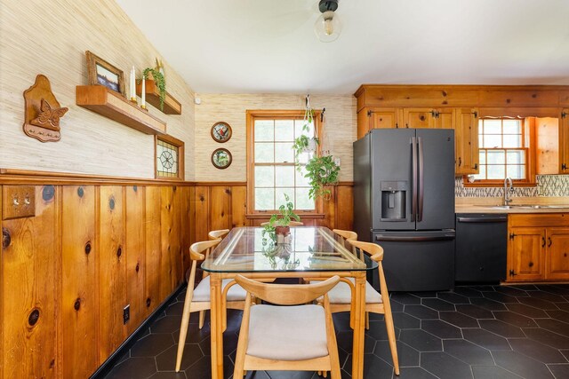 4600 Saunders Ave, Nashville, TN 37216 - dining area featuring wainscoting, wooden walls, and dark tile patterned floors