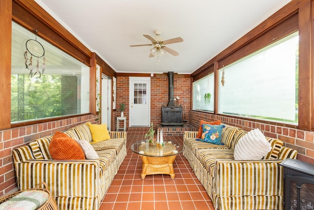 4600 Saunders Ave, Nashville, TN 37216 - sunroom featuring a wood stove, outdoor lounge area, a ceiling fan, brick wall, and tile patterned floors