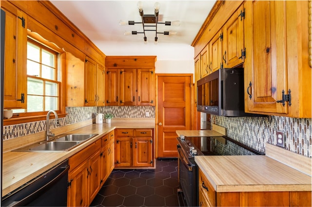 4600 Saunders Ave, Nashville, TN 37216 - kitchen with black appliances, a sink, decorative backsplash, dark tile patterned floors, and brown cabinetry