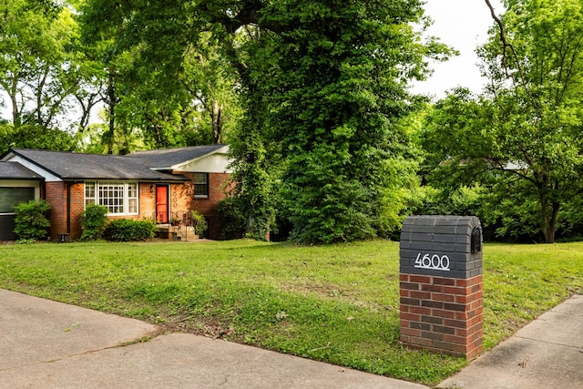 4600 Saunders Ave, Nashville, TN 37216 - view of front of house with a front yard, brick siding, and a shingled roof