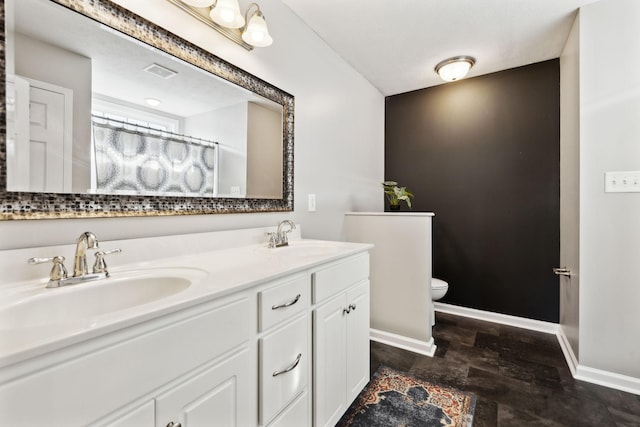 215 Azalea Dr, Oak Grove, KY 42262 - bathroom featuring double vanity, toilet, and baseboards