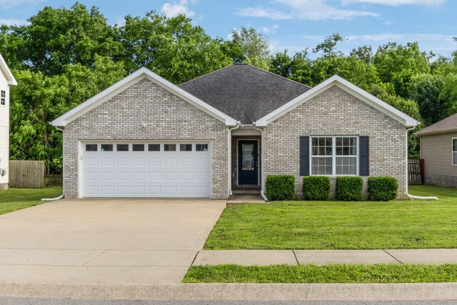 215 Azalea Dr, Oak Grove, KY 42262 - ranch-style home featuring a garage, driveway, brick siding, and roof with shingles