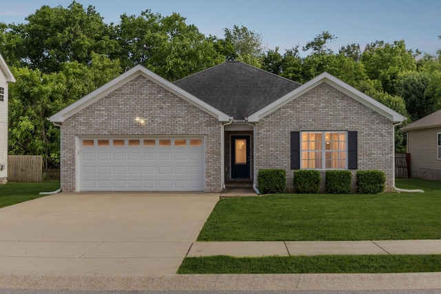 215 Azalea Dr, Oak Grove, KY 42262 - single story home featuring an attached garage, concrete driveway, brick siding, and roof with shingles