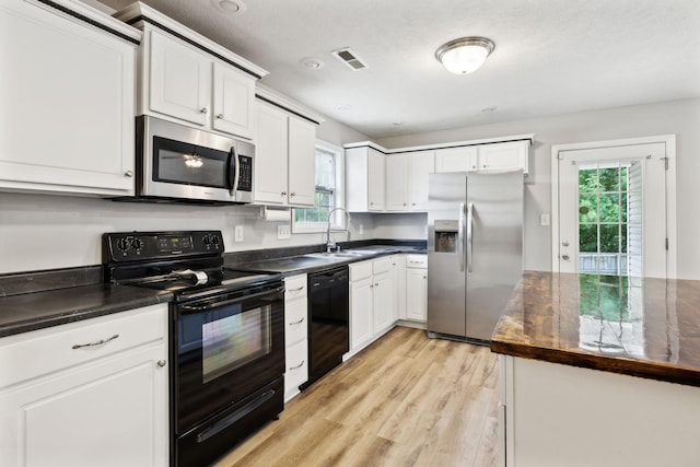 215 Azalea Dr, Oak Grove, KY 42262 - kitchen featuring black appliances, a sink, dark countertops, and light wood-style flooring
