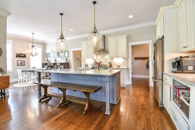 2914 Chasepointe Pl, Columbia, TN 38401 - kitchen with wall chimney range hood, freestanding refrigerator, light stone counters, tasteful backsplash, and a breakfast bar area