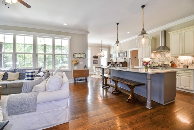 2914 Chasepointe Pl, Columbia, TN 38401 - kitchen with wall chimney range hood, a kitchen bar, dark wood-style floors, ceiling fan, and recessed lighting