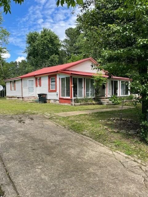 103 E High St, Ethridge, TN 38456 - view of front of property featuring a front lawn, metal roof, and crawl space