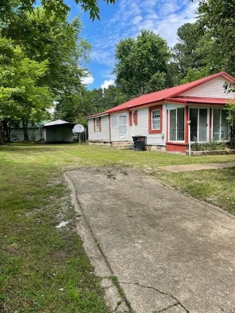 103 E High St, Ethridge, TN 38456 - view of front facade with a detached carport, a front yard, and crawl space