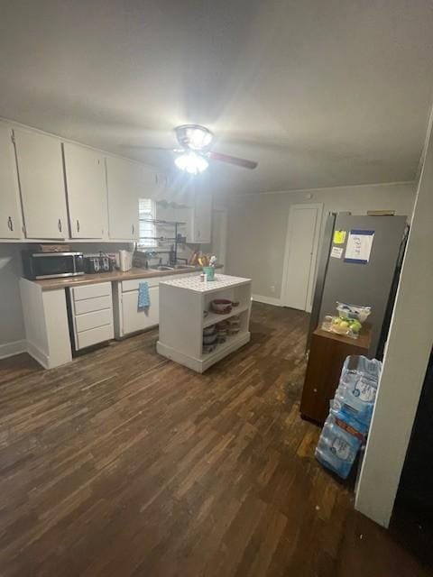 103 E High St, Ethridge, TN 38456 - kitchen with white cabinets, dark wood finished floors, appliances with stainless steel finishes, ceiling fan, and light countertops