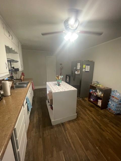 103 E High St, Ethridge, TN 38456 - kitchen featuring stainless steel fridge, a ceiling fan, dark wood finished floors, white cabinetry, and crown molding
