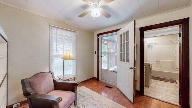1009 5th Ave W, Springfield, TN 37172 - living area with crown molding, plenty of natural light, light wood-type flooring, and ceiling fan