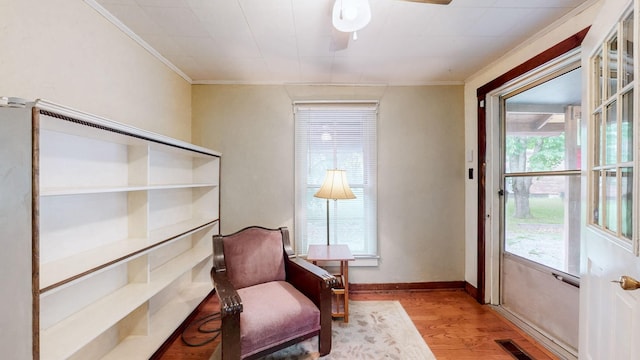 1009 5th Ave W, Springfield, TN 37172 - living area featuring wood finished floors, ornamental molding, plenty of natural light, baseboards, and a ceiling fan