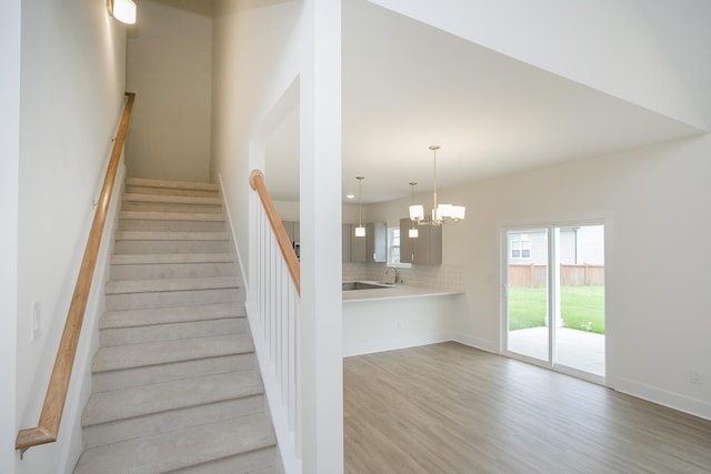 324 Fieldstone Ln, Springfield, TN 37172 - stairway with wood finished floors, a chandelier, and baseboards