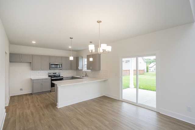 324 Fieldstone Ln, Springfield, TN 37172 - kitchen with stainless steel appliances, gray cabinetry, a sink, wood finished floors, and light countertops