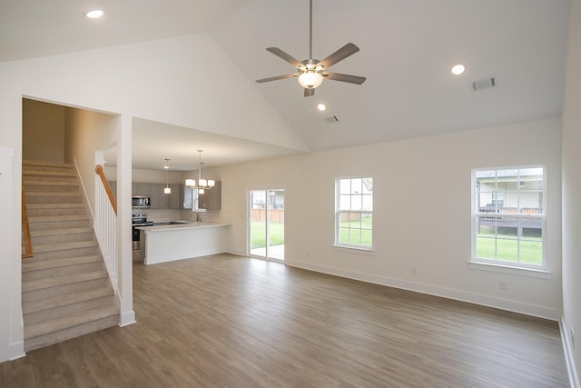 324 Fieldstone Ln, Springfield, TN 37172 - unfurnished living room featuring a chandelier, healthy amount of natural light, high vaulted ceiling, stairs, and ceiling fan
