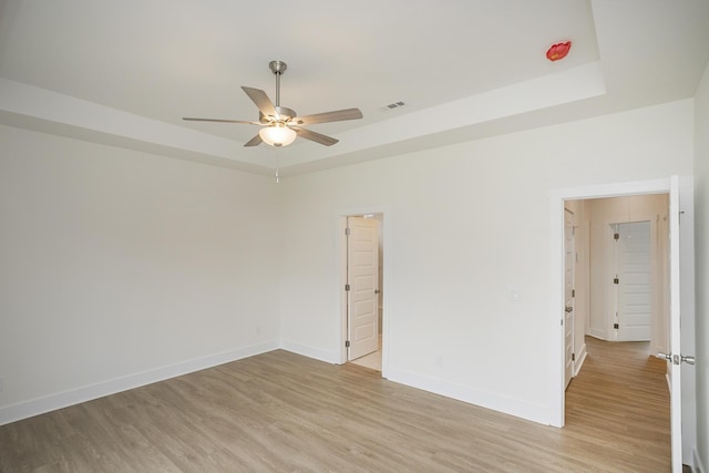324 Fieldstone Ln, Springfield, TN 37172 - empty room with a ceiling fan, light wood-style flooring, a tray ceiling, and baseboards