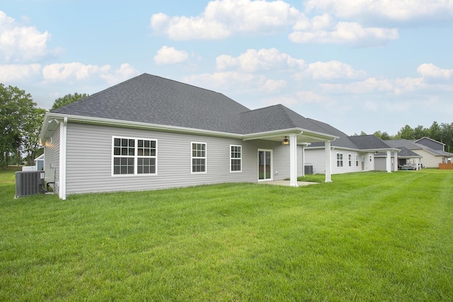 324 Fieldstone Ln, Springfield, TN 37172 - back of house featuring central AC, roof with shingles, and a lawn
