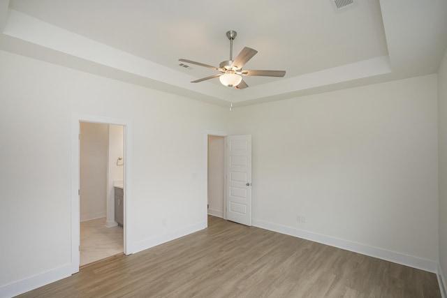 324 Fieldstone Ln, Springfield, TN 37172 - empty room with a raised ceiling, ceiling fan, light wood-style floors, and baseboards