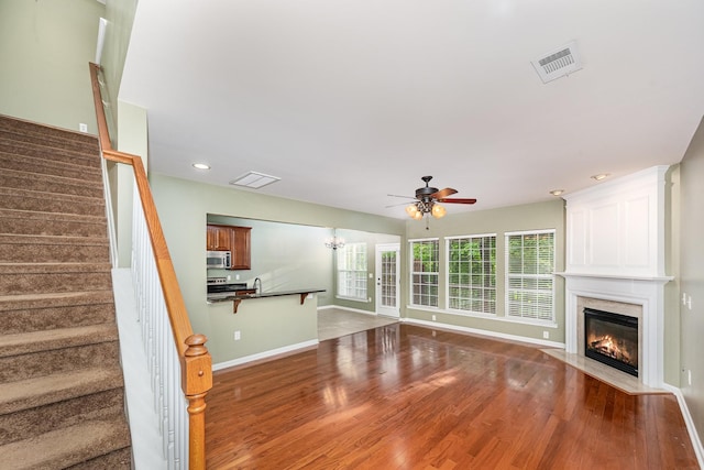443 Lazy Creek Ln, Nashville, TN 37211 - unfurnished living room with ceiling fan, a fireplace, wood finished floors, baseboards, and stairway