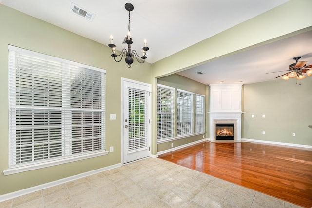 443 Lazy Creek Ln, Nashville, TN 37211 - unfurnished living room featuring a chandelier, ceiling fan, a large fireplace, and baseboards