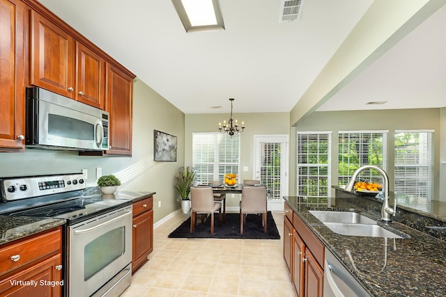 443 Lazy Creek Ln, Nashville, TN 37211 - kitchen with stainless steel appliances, a sink, dark stone counters, a chandelier, and light tile patterned flooring