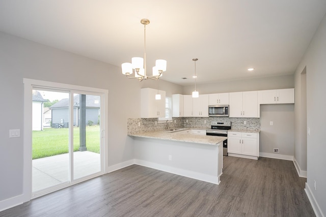 302 Fieldstone Ln, Springfield, TN 37172 - kitchen with appliances with stainless steel finishes, a peninsula, decorative backsplash, white cabinets, and dark wood-type flooring
