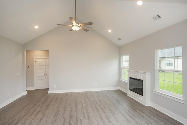 302 Fieldstone Ln, Springfield, TN 37172 - unfurnished living room with high vaulted ceiling, a ceiling fan, plenty of natural light, wood finished floors, and a glass covered fireplace