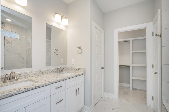 302 Fieldstone Ln, Springfield, TN 37172 - bathroom with marble finish flooring, double vanity, baseboards, and a walk in closet