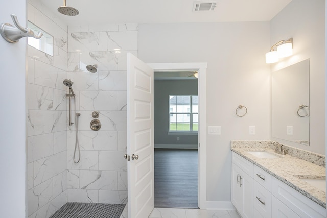 302 Fieldstone Ln, Springfield, TN 37172 - full bathroom featuring double vanity, marble finish flooring, baseboards, and tiled shower