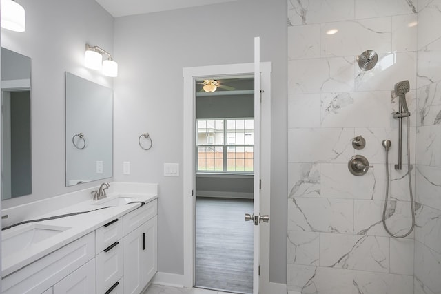 340 Fieldstone Ln, Springfield, TN 37172 - bathroom featuring ceiling fan, double vanity, a tile shower, and baseboards