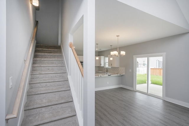 340 Fieldstone Ln, Springfield, TN 37172 - stairs with wood finished floors, a chandelier, and baseboards