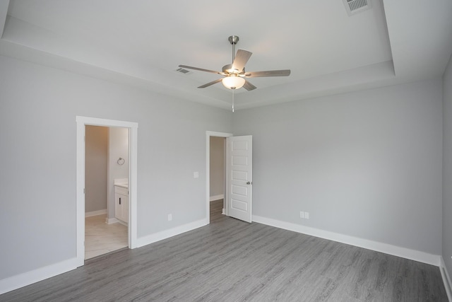 340 Fieldstone Ln, Springfield, TN 37172 - unfurnished bedroom with wood finished floors, a tray ceiling, and baseboards