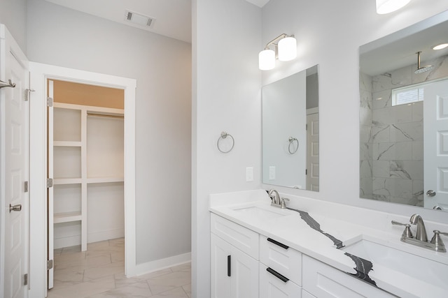 340 Fieldstone Ln, Springfield, TN 37172 - full bath featuring marble look tile flooring, a walk in closet, double vanity, a marble finish shower, and baseboards